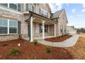 Charming front porch with stone accents and craftsman columns for a welcoming entryway at 805 Dobby Way (Lot 93), Mcdonough, GA 30252