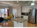 Open kitchen featuring granite counters, stainless appliances, and a breakfast nook with natural light at 2860 Pine St, Duluth, GA 30096