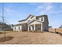 Charming home featuring a covered porch with stone accents and neutral siding at 809 Dobby Way (Lot 94), Mcdonough, GA 30252