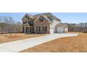 Side view of a beautiful two-story home with a two-car garage and long driveway at 816 Dobby Way (Lot 100), Mcdonough, GA 30252