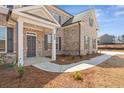 Inviting front entrance with a stylish door and manicured landscaping at 816 Dobby Way (Lot 100), Mcdonough, GA 30252