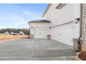 Close-up of the three-car garage with white doors and sleek black hardware at 800 Dobby Way (Lot 104), Mcdonough, GA 30252