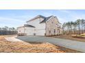 Spacious three-car garage with a long driveway, providing ample parking space at 800 Dobby Way (Lot 104), Mcdonough, GA 30252