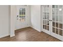 Elegant foyer featuring rich hardwood floors and a glass-paneled front door, creating a bright and inviting entrance at 267 Arwen Drive (Lot 66), Mcdonough, GA 30252