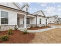 A beautiful single Gathering home with a manicured lawn and covered porch and visible home exterior at 708 Hedwig Drive (Lot 89), Mcdonough, GA 30252