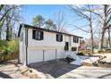 Two-story home featuring an attached garage and painted driveway at 3959 Emerald Springs Ct, Decatur, GA 30035