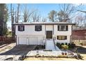 Charming two-story home with a black and white paint scheme, attached garage, and landscaped front yard at 3959 Emerald Springs Ct, Decatur, GA 30035