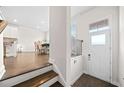 Bright foyer with hardwood floors, a white front door, and staircase leading to upper level at 4344 Colorado Fir Aly, Doraville, GA 30360