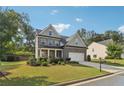 Attractive two-story home featuring a brick facade, a two-car garage, and a well-maintained front lawn at 6235 Banyan Trl, Cumming, GA 30028