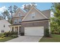Beautiful two-story house boasting a brick exterior, a two-car garage, and a well-cared-for garden at 6235 Banyan Trl, Cumming, GA 30028