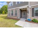 Charming townhome with a stone and gray siding facade, and a welcoming covered front entrance at 6701 Cedar Glen Rd, Peachtree Corners, GA 30071