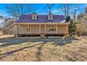 Inviting home with a cozy front porch and a classic metal roof design at 436 Tarpley Ave, Bowdon, GA 30108