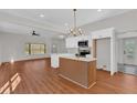 Bright open-concept kitchen features white cabinets, island, and modern finishes at 436 Tarpley Ave, Bowdon, GA 30108