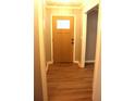 Inviting foyer featuring warm wood-look floors and a stylish front door at 823 Mount Tabor Rd, Oxford, GA 30054