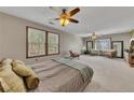Spacious main bedroom featuring dual ceiling fans, lots of natural light, and cozy decor at 920 Pine Grove Pointe Dr, Roswell, GA 30075