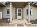 Inviting front porch with stone accents, stylish lighting, and a welcoming entrance, enhancing curb appeal at 1684 Braeburn Se Dr, Atlanta, GA 30316
