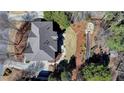 Expansive backyard featuring a stone patio and manicured lawn, perfect for outdoor gatherings at 210 Eden Bridge Pl, Johns Creek, GA 30022