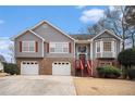 Charming two-story home featuring gray siding, brick accents, and a well-manicured lawn at 2901 Soapstone Ct, Powder Springs, GA 30127