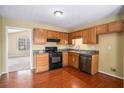 Traditional kitchen featuring wood cabinets, granite countertops, and modern black appliances at 2901 Soapstone Ct, Powder Springs, GA 30127