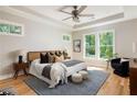 Serene main bedroom with tray ceiling, ceiling fan, multiple windows, and neutral décor at 1208 Thomas Rd, Decatur, GA 30030