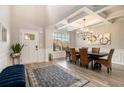 Dining room with decorative chandelier, coffered ceilings, and blue accent bench at 263 Osier Dr, Mcdonough, GA 30252