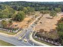 Serene view of the community entrance, featuring stone pillars and manicured landscaping, inviting exploration at 4415 Natchez Ln, Cumming, GA 30040