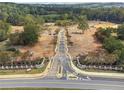 Grand community entrance lined with trees and decorative fences in a quiet setting at 4525 Muskogee Ct, Cumming, GA 30040