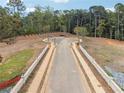 New road construction in a planned community with landscaped street and retaining wall at 4525 Muskogee Ct, Cumming, GA 30040