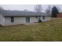 The backyard with a patio features a well-maintained lawn, and mature trees at 10 Oak Wood Ln, Covington, GA 30016