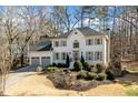 Beautiful two-story home with landscaped front yard and attached two-car garage in wooded area at 2833 Landing Way, Marietta, GA 30066