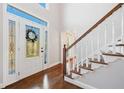 Inviting foyer with hardwood floors, staircase, and decorative glass front door at 2833 Landing Way, Marietta, GA 30066