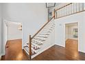 Open foyer showcasing hardwood floors and staircase, leading to spacious rooms and ample lighting at 2833 Landing Way, Marietta, GA 30066