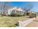 Inviting single-story house showcasing a cozy porch and a lush green front yard at 1763 Mercer Ave, Atlanta, GA 30337