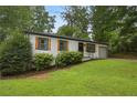 Inviting single-story home with green lawn and wood shutters, nestled in a quiet, tree-lined neighborhood at 3314 Creatwood Se Trl, Smyrna, GA 30080