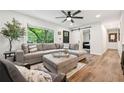 Spacious living room with hardwood floors, a cozy sectional sofa, and natural light at 3314 Creatwood Se Trl, Smyrna, GA 30080