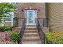 Inviting front entrance with brick steps, iron railing, and a decorative white door at 114 Farm Valley Dr, Canton, GA 30115