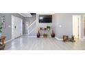 Open living room with tile floors, staircase, and decorative vases on a side table at 5099 Leeshire Trce, Tucker, GA 30084