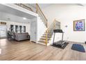 Bright living area with beautiful staircase, wood floors, and seamless transition to living room at 1208 Lauren Nw Ct, Acworth, GA 30101