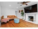 Inviting living room boasts hardwood floors, fireplace, with a comfortable leather couch, and stylish accents at 1428 Downs Sw Dr, Atlanta, GA 30311