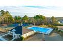 Community pool and tennis courts surrounded by trees in a serene setting at Water Oak Estates at 1838 Lacebark Elm Way, Lawrenceville, GA 30045