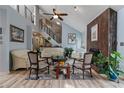 Spacious living room with vaulted ceilings, a fireplace, and large windows providing natural light at 2590 Runic Way, Johns Creek, GA 30022