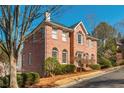 Elegant two-story brick home with manicured landscaping and traditional architectural details at 1231 Wildcliff Cir, Atlanta, GA 30329