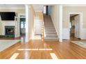 Inviting home foyer featuring hardwood floors, staircase, and a glimpse of the fireplace and kitchen at 1231 Wildcliff Cir, Atlanta, GA 30329