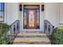 Close-up of the home's beautiful front door with sidelights and stone steps at 18 Peppertree Ct, Marietta, GA 30068