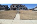 Charming two-story home with a mix of brick and siding, complemented by a well-manicured lawn at 3817 Bay Orchard Ln, Loganville, GA 30052
