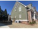 Side view of home showing neutral siding, brick accents and manicured lawn at 3817 Bay Orchard Ln, Loganville, GA 30052