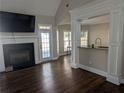 Cozy living room featuring a fireplace, hardwood floors, and natural light at 510 Pittman Mill Ct, Loganville, GA 30052