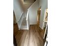 Inviting foyer with wood floors, a staircase, and views of the powder room at 1114 Campbell Rd, Covington, GA 30014