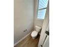 Cozy powder room with a toilet and wood floors at 1114 Campbell Rd, Covington, GA 30014
