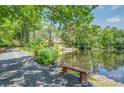 Scenic view of a lakefront home with a private driveway and lush landscaping at 127 Hamby Ln, Social Circle, GA 30025